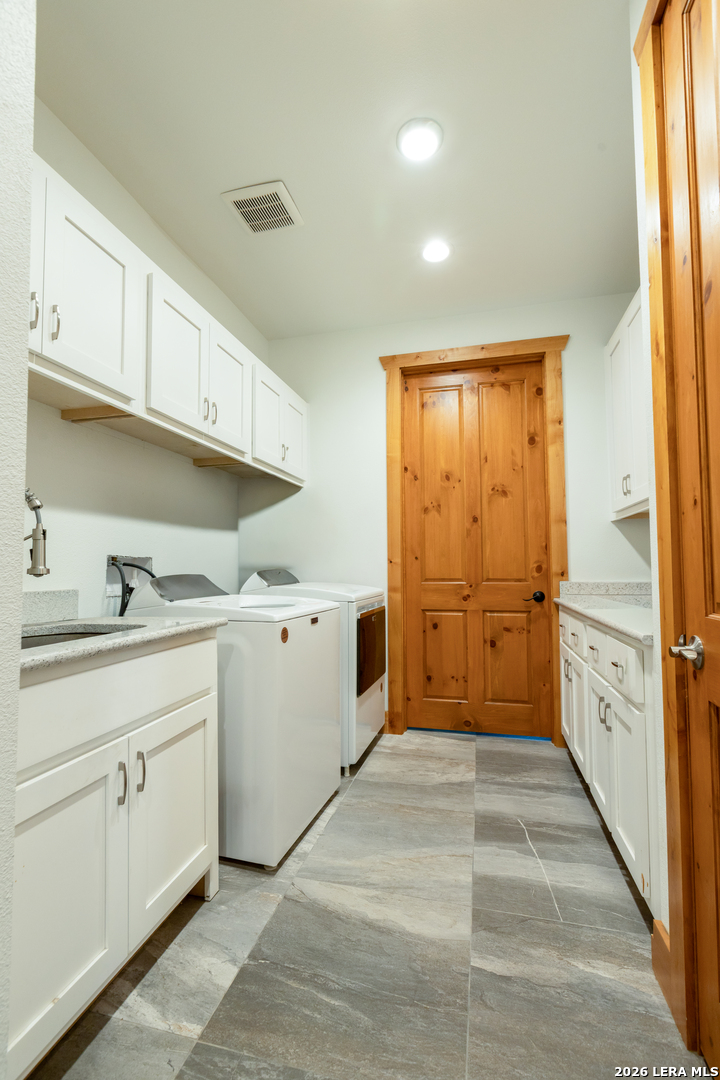 525 Windmill Drive Bandera, TX 78003 - Photo 14 of 28 a utility room with cabinets washer and dryer