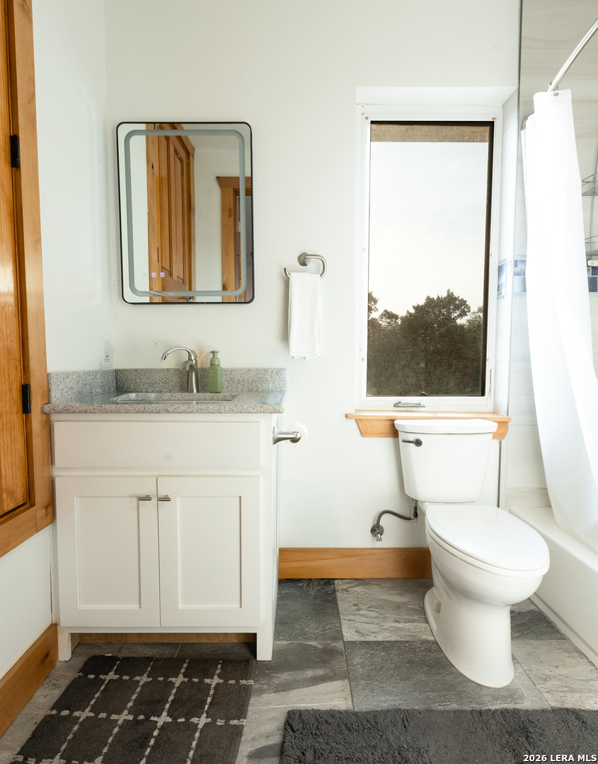 525 Windmill Drive Bandera, TX 78003 - Photo 17 of 28 a bathroom with a sink toilet and mirror