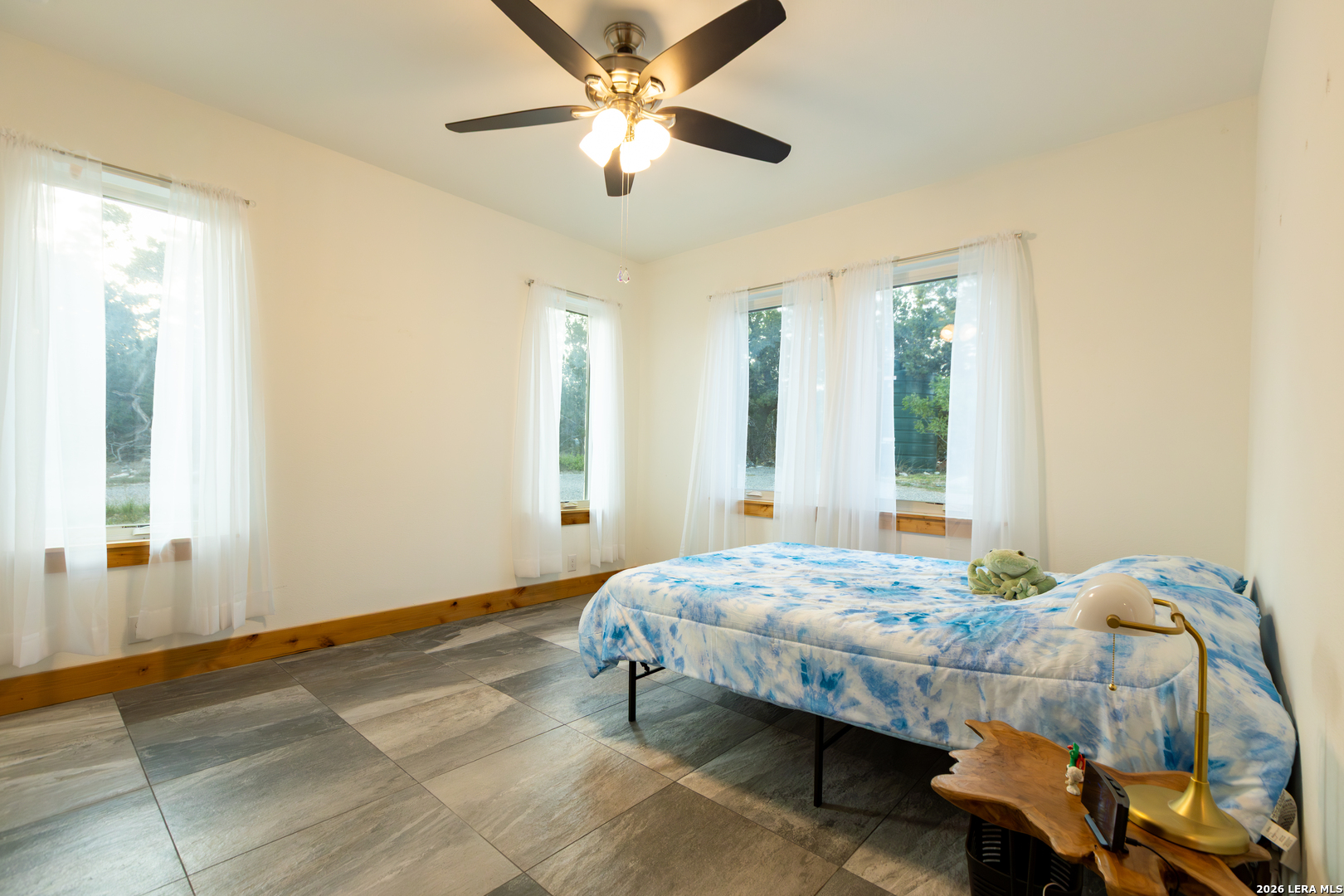 525 Windmill Drive Bandera, TX 78003 - Photo 19 of 28 a bedroom with a bed and a chandelier