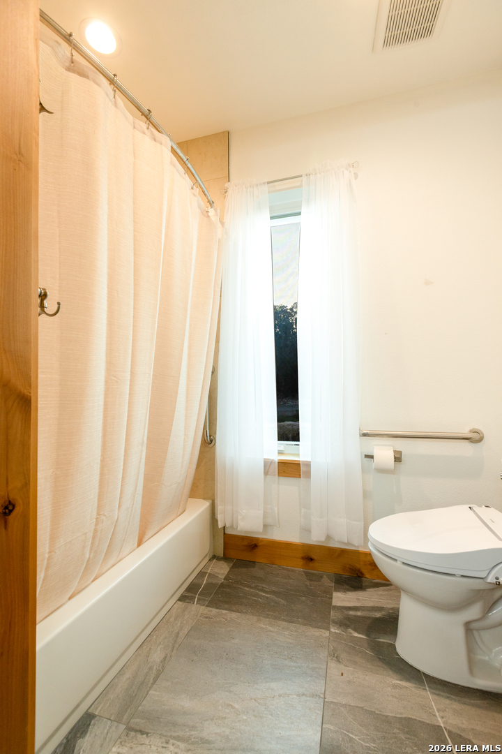 525 Windmill Drive Bandera, TX 78003 - Photo 21 of 28 a bathroom with a toilet and a shower