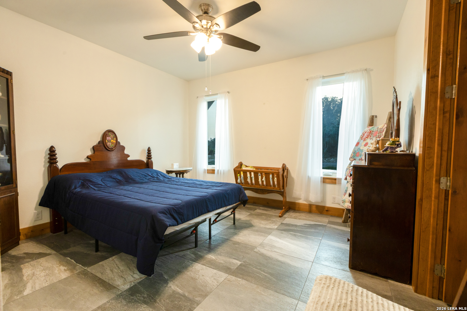525 Windmill Drive Bandera, TX 78003 - Photo 22 of 28 a spacious bedroom with a bed and wooden floor
