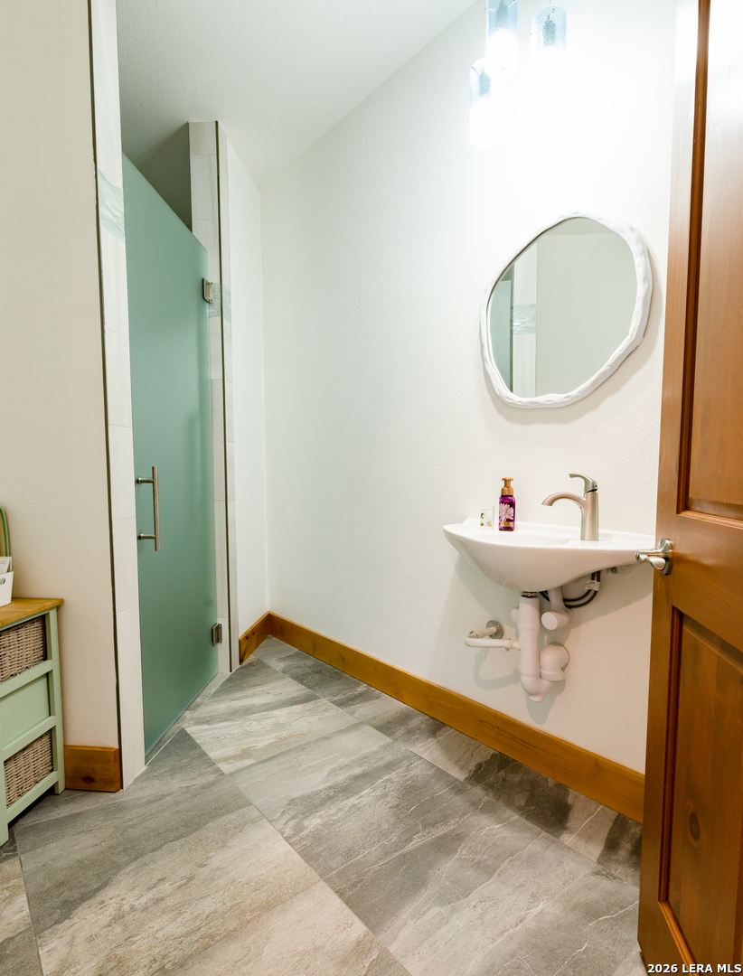 525 Windmill Drive Bandera, TX 78003 - Photo 24 of 28 a bathroom with a sink and a mirror