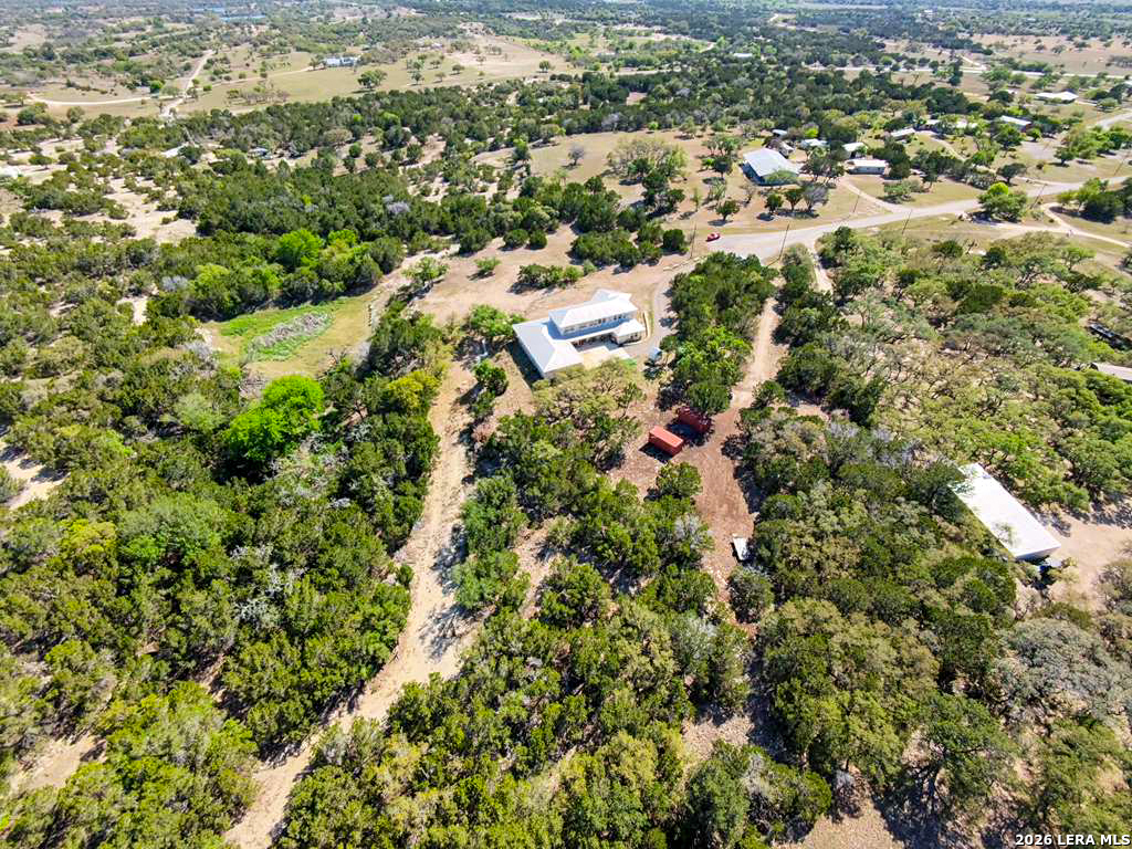 525 Windmill Drive Bandera, TX 78003 - Photo 28 of 28 an aerial view of residential house with parking and trees