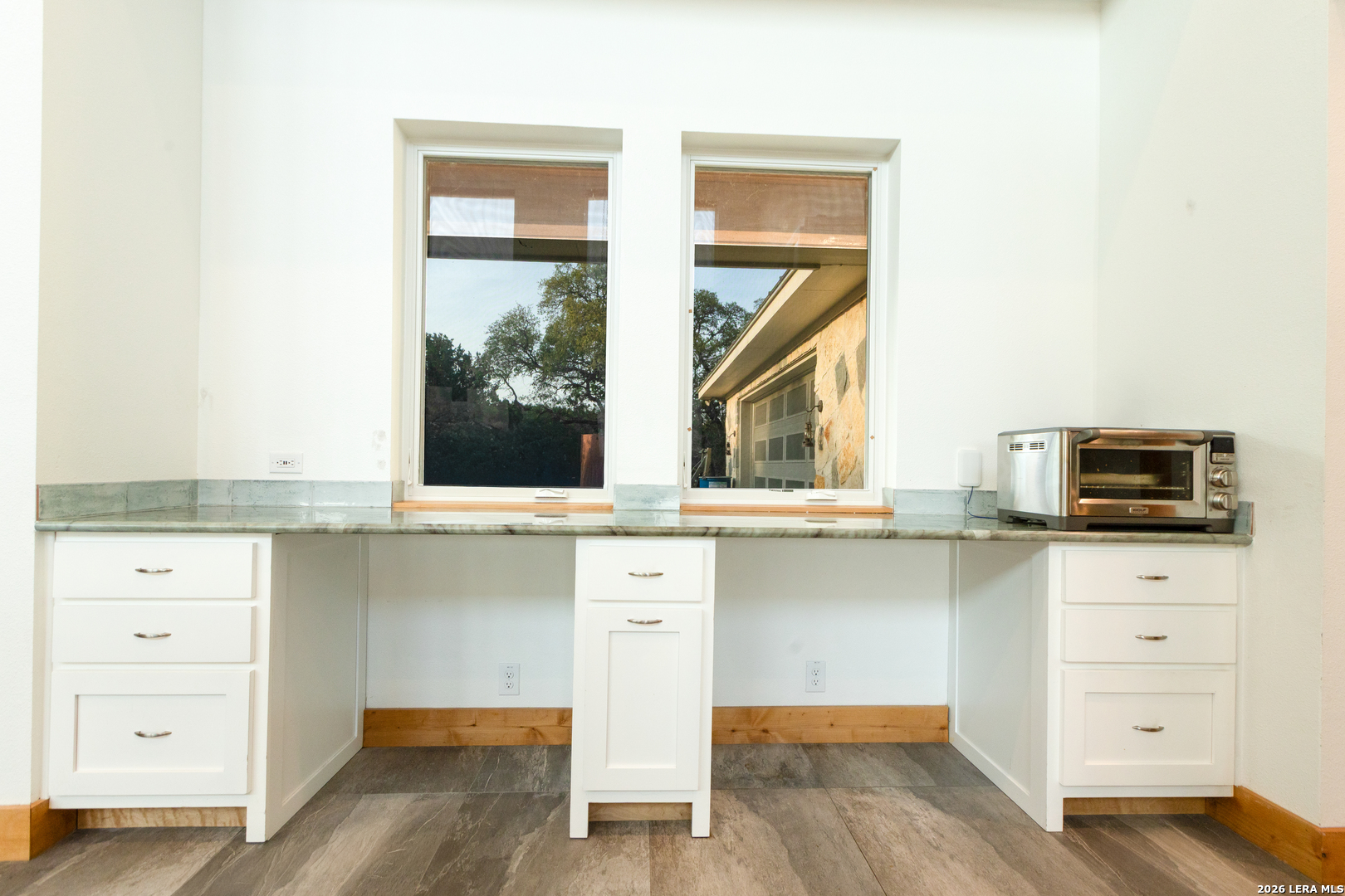 525 Windmill Drive Bandera, TX 78003 - Photo 6 of 28 a kitchen with a sink window and a refrigerator