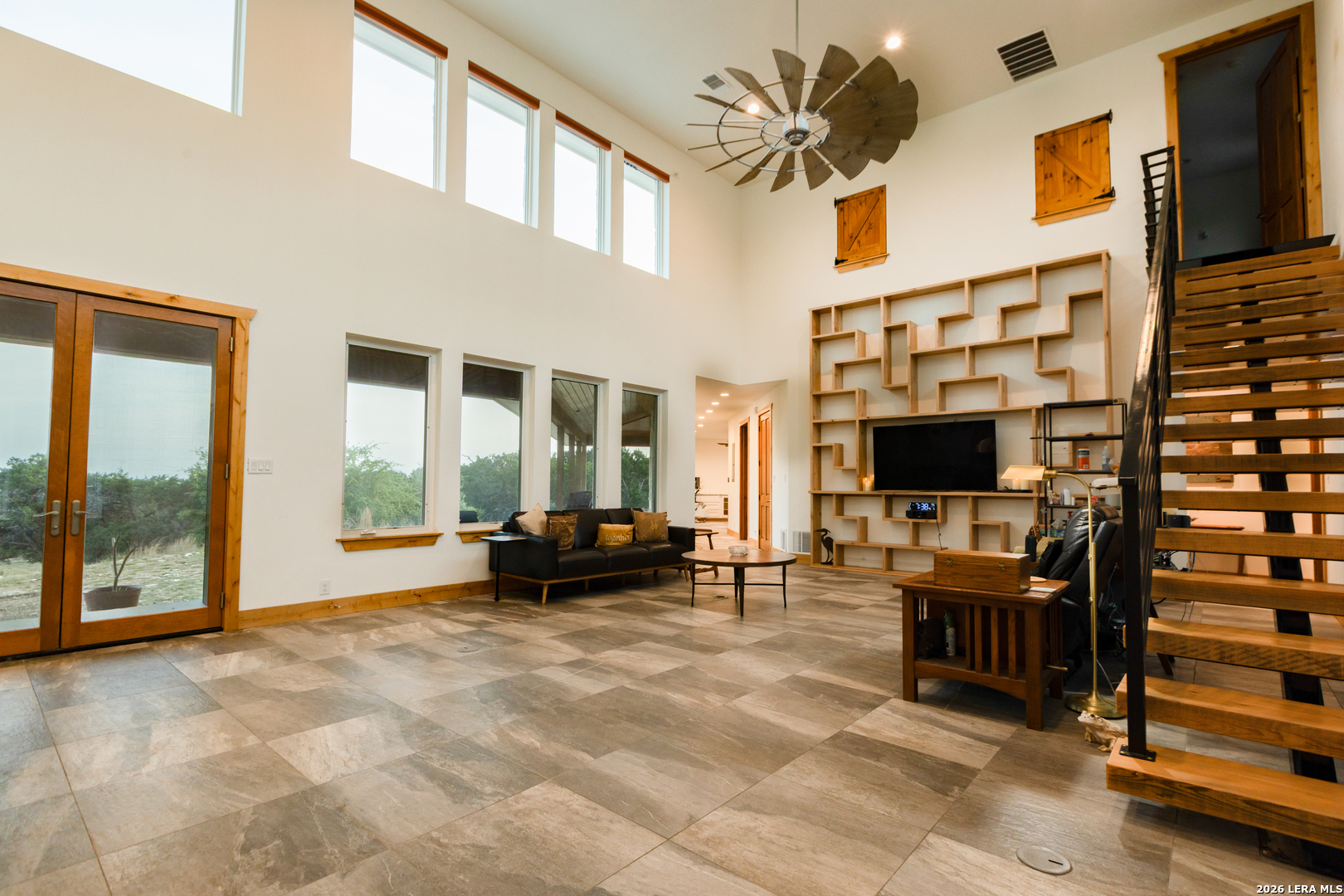 525 Windmill Drive Bandera, TX 78003 - Photo 8 of 28 a living room with furniture a flat screen tv and large windows