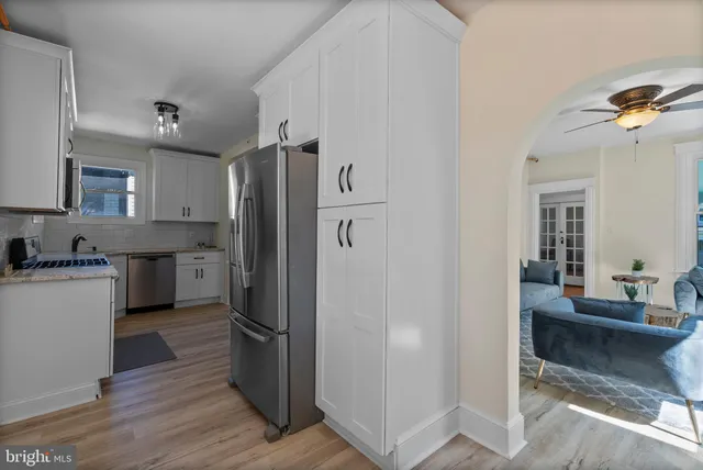 a kitchen with stainless steel appliances granite countertop a stove and a refrigerator