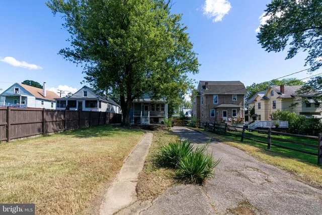 a view of backyard with outdoor seating and green space