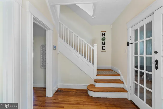 a view of entryway and hall with wooden floor