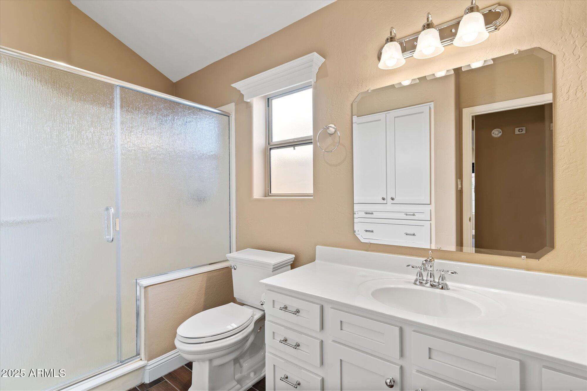 5534 North 15th Street Phoenix, AZ 85014 - Photo 21 of 25 a bathroom with a toilet a sink and a large mirror