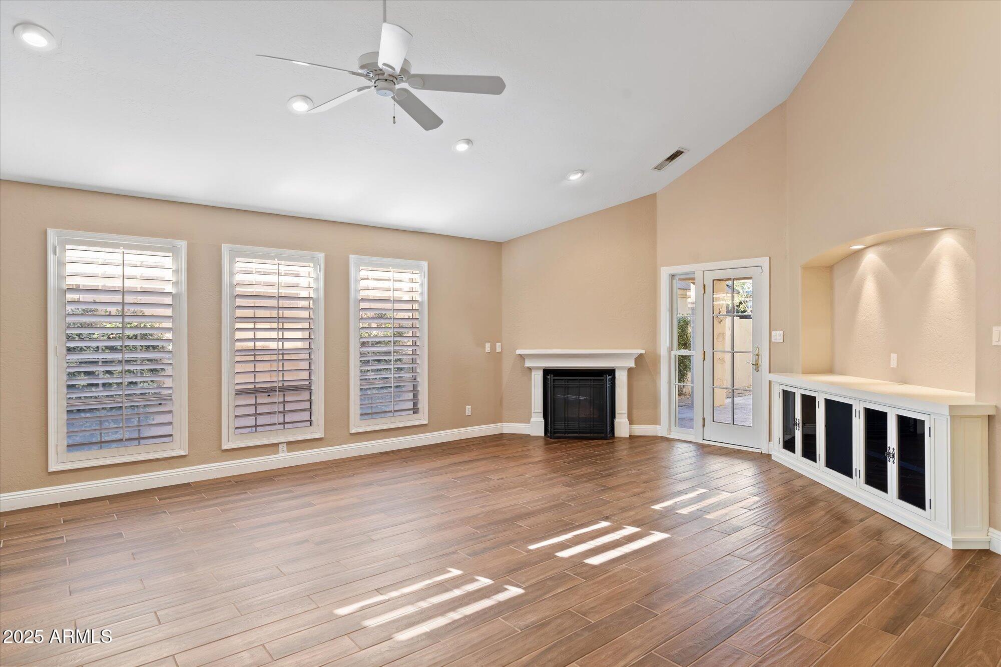 5534 North 15th Street Phoenix, AZ 85014 - Photo 3 of 25 a view of empty room with fireplace and wooden floor