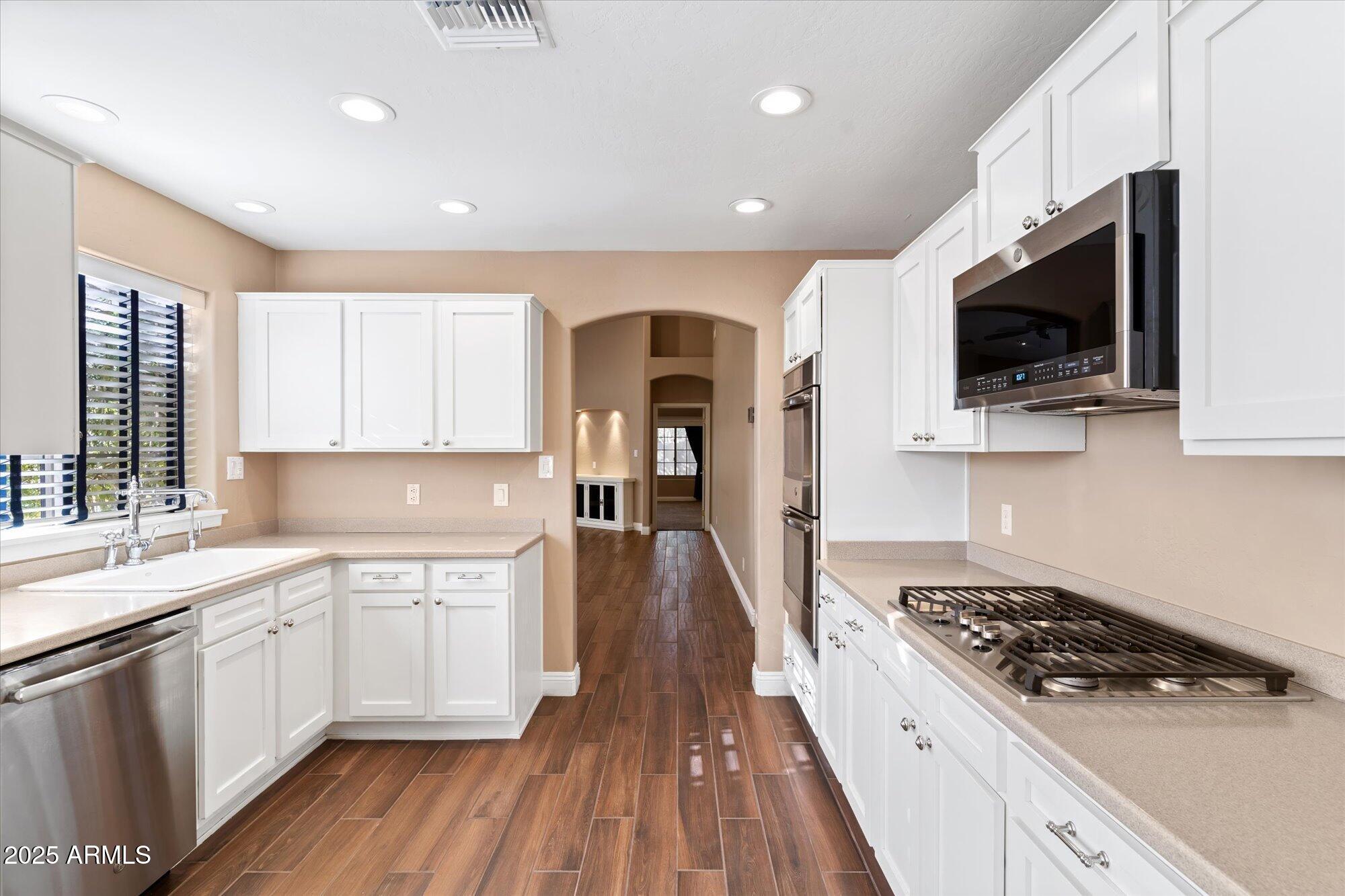 5534 North 15th Street Phoenix, AZ 85014 - Photo 7 of 25 a kitchen with a sink a microwave and cabinets