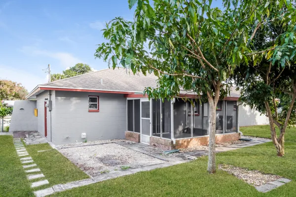 a house that has a tree in front of it
