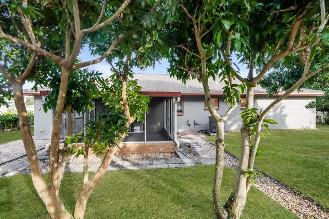 a view of a house with a yard and sitting area