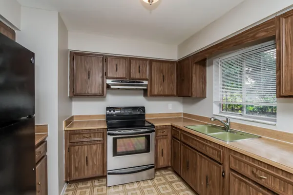 a kitchen with a sink stove and microwave