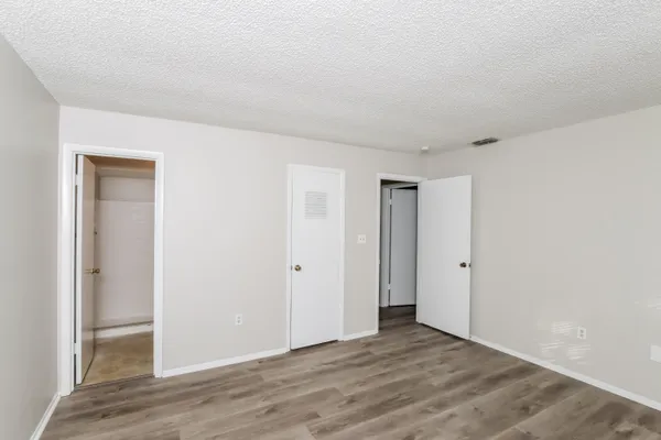 a view of an empty room and wooden floor