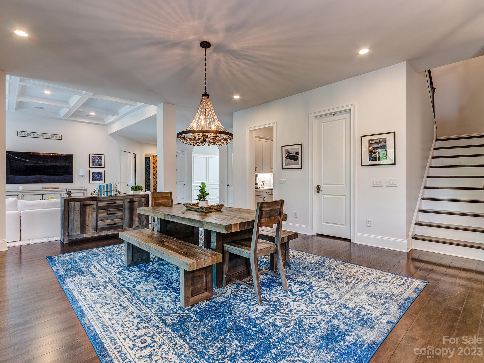 411 Turtleback Ridge Weddington, NC 28104 - Photo 11 of 48 a view of a dining room and livingroom with furniture wooden floor and a rug