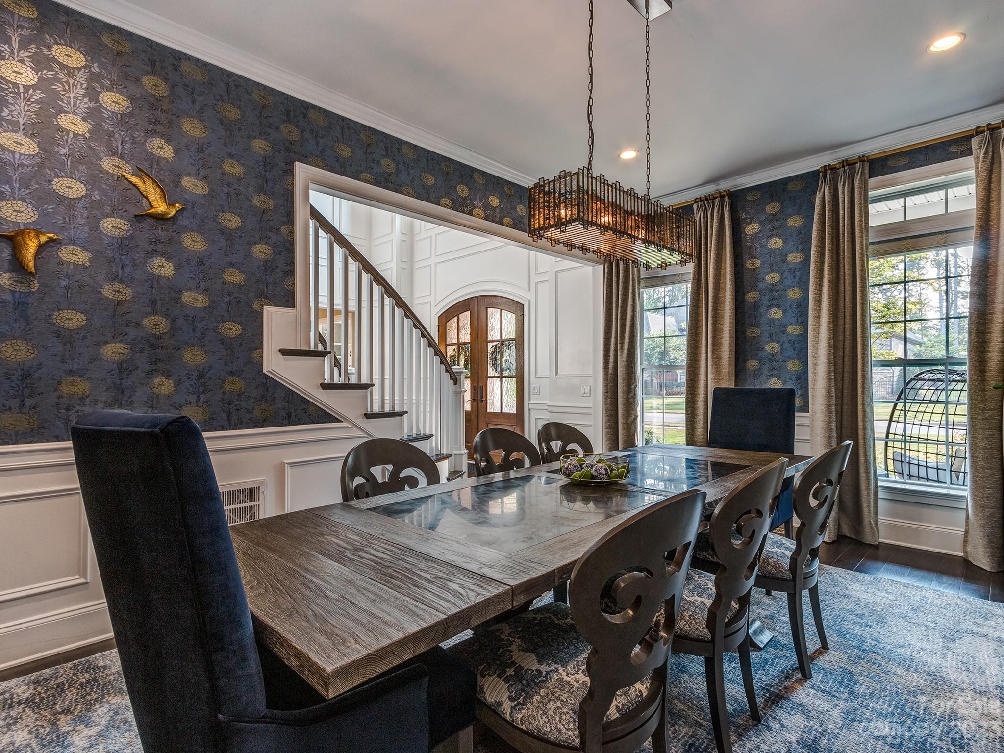 411 Turtleback Ridge Weddington, NC 28104 - Photo 19 of 48 a dining room with furniture a chandelier and window