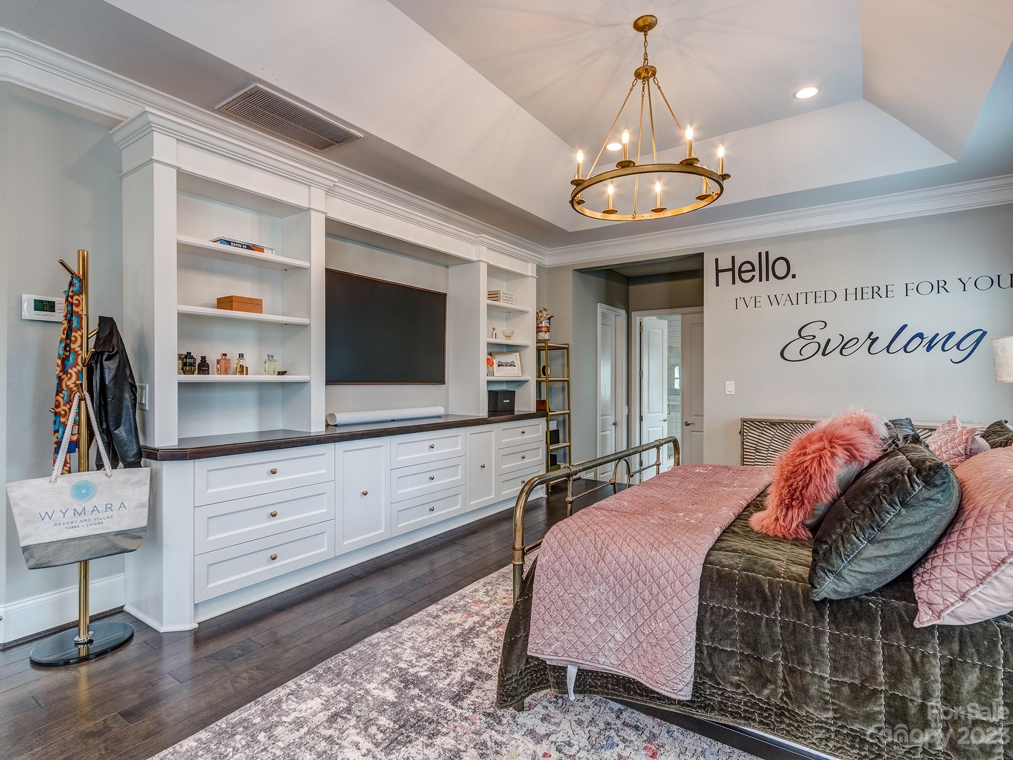 411 Turtleback Ridge Weddington, NC 28104 - Photo 25 of 48 a bedroom with a bed and a flat screen tv