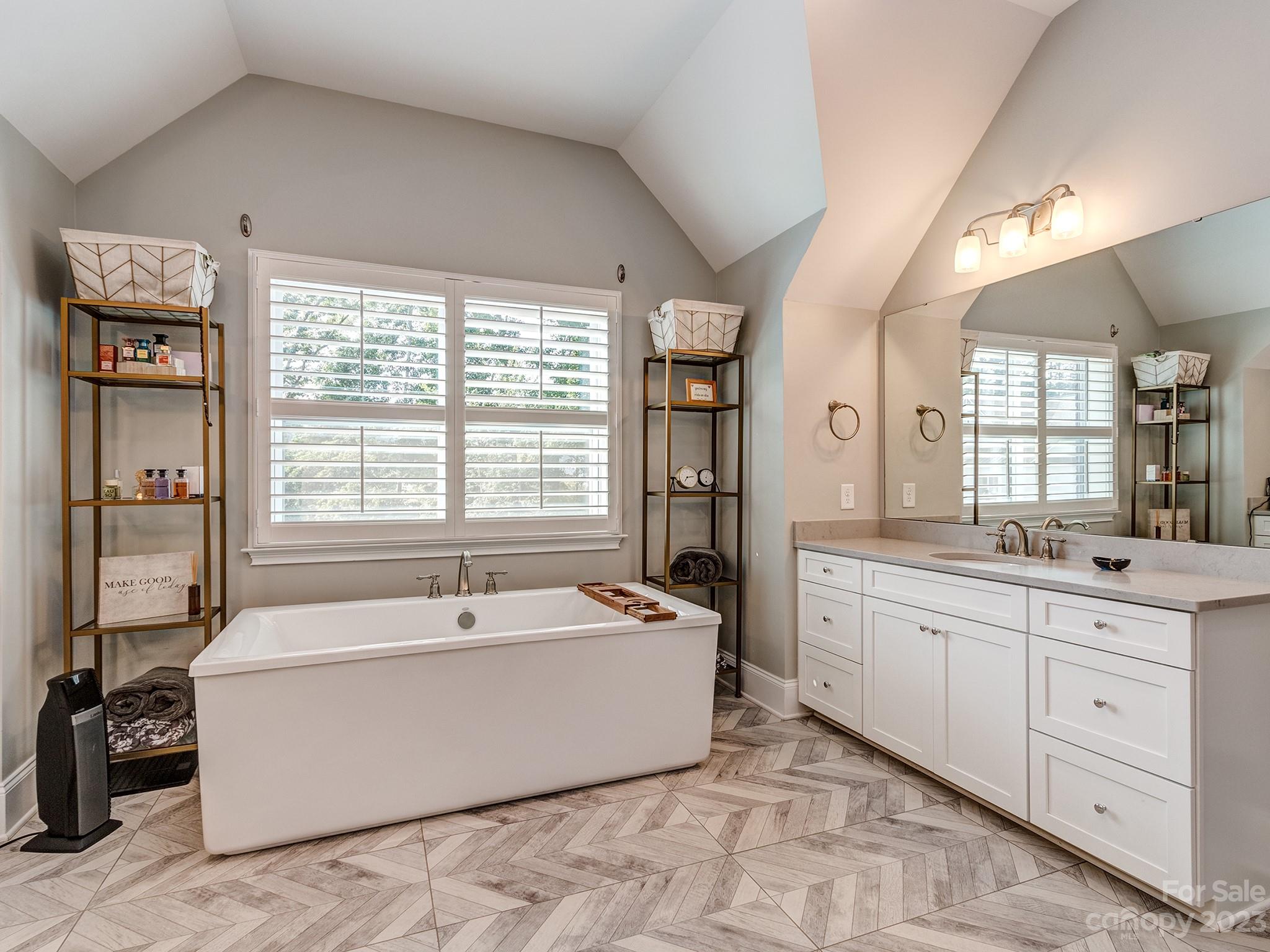 411 Turtleback Ridge Weddington, NC 28104 - Photo 27 of 48 a spacious bathroom with a tub double sink window and mirror
