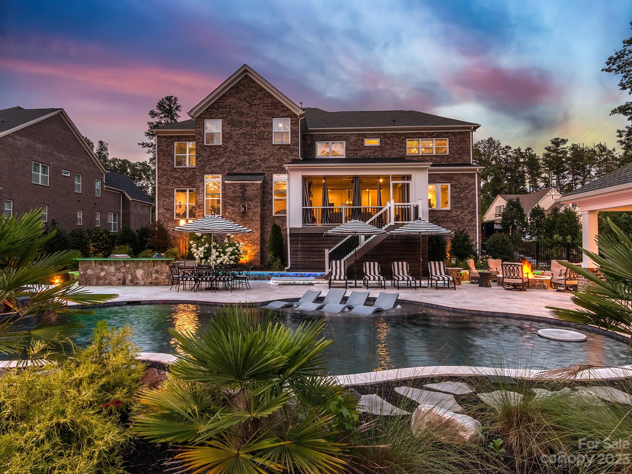 411 Turtleback Ridge Weddington, NC 28104 - Photo 3 of 48 a front view of a house with swimming pool yard and outdoor seating