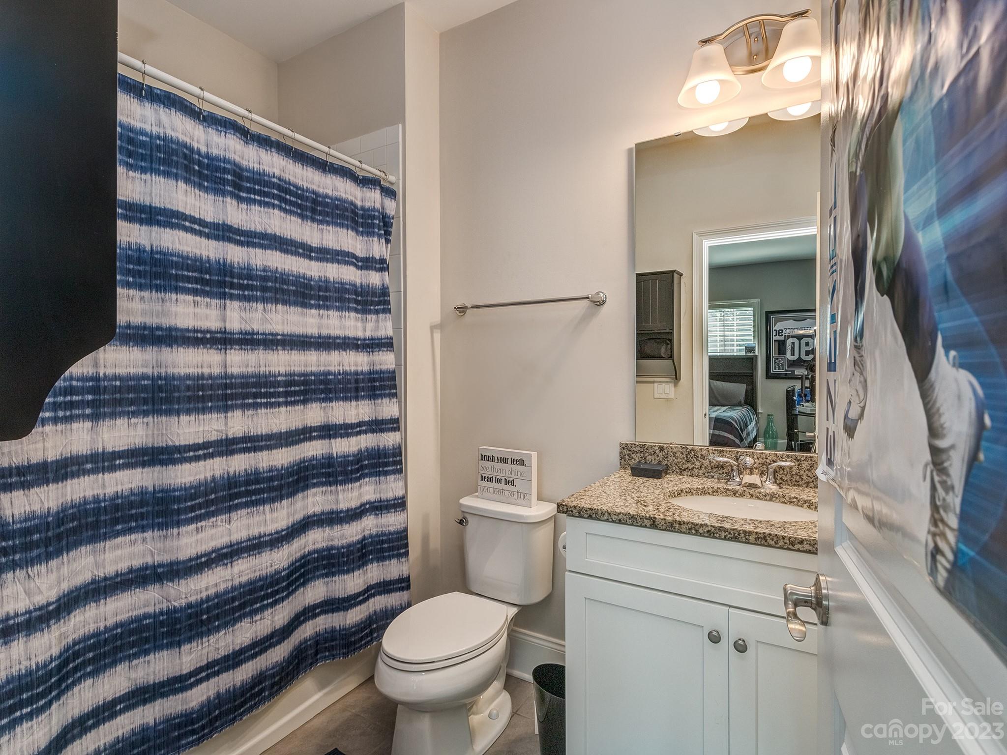 411 Turtleback Ridge Weddington, NC 28104 - Photo 31 of 48 a bathroom with a granite countertop sink toilet and shower