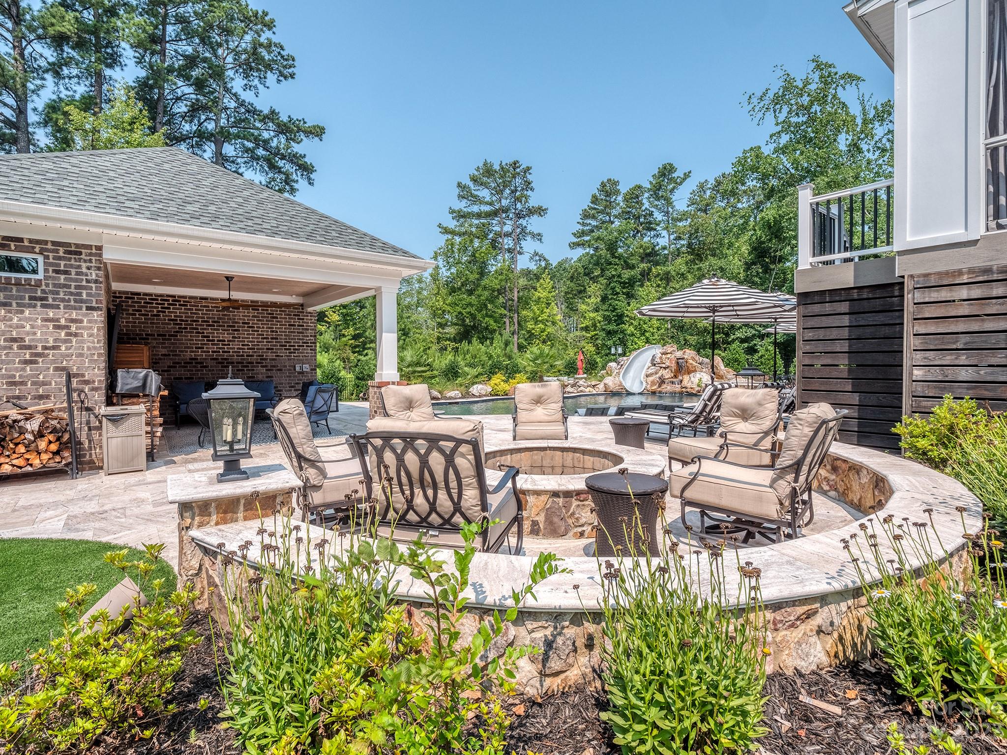 411 Turtleback Ridge Weddington, NC 28104 - Photo 36 of 48 a view of a patio with table and chairs potted plants and large tree