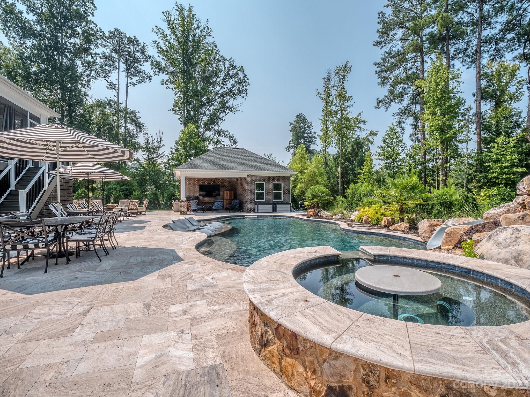 411 Turtleback Ridge Weddington, NC 28104 - Photo 41 of 48 a view of a swimming pool with chairs in patio
