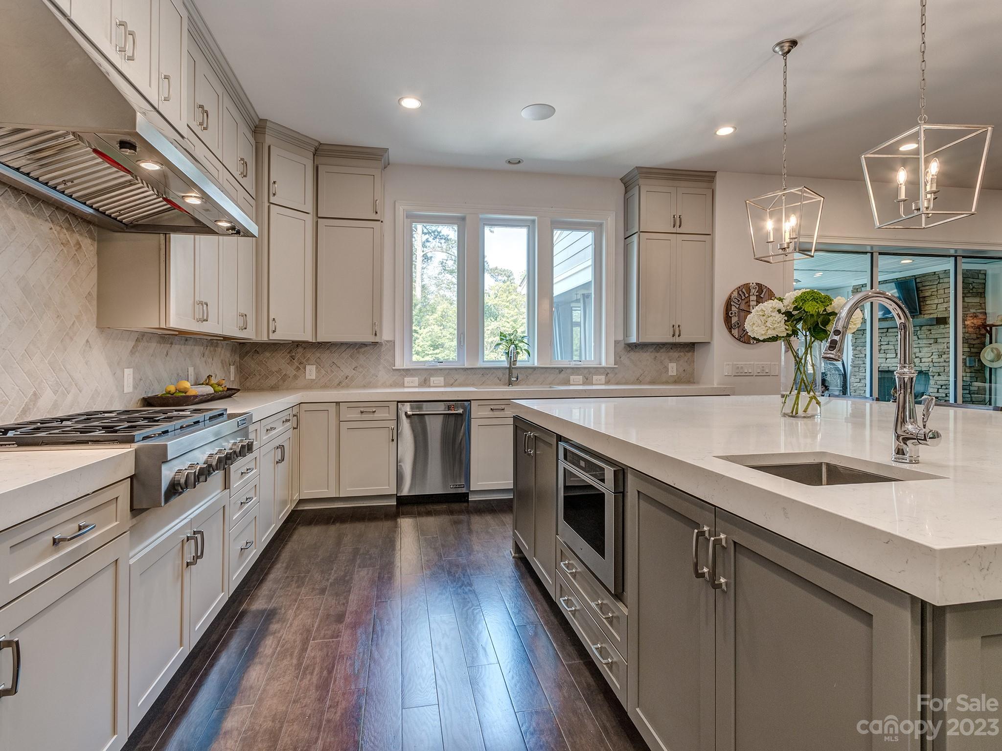 411 Turtleback Ridge Weddington, NC 28104 - Photo 8 of 48 a kitchen with stainless steel appliances granite countertop a sink a stove and a wooden floors