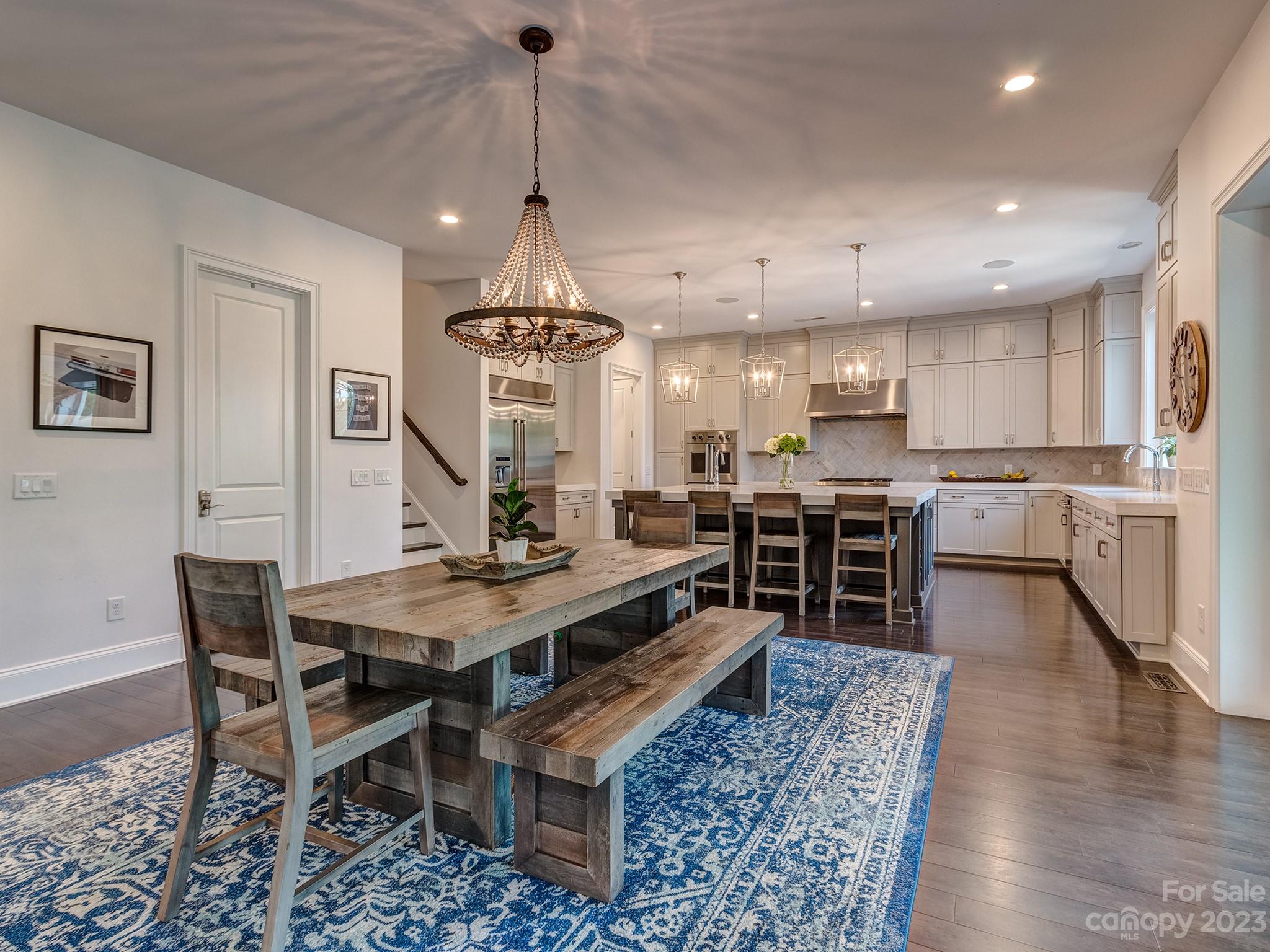 411 Turtleback Ridge Weddington, NC 28104 - Photo 10 of 48 a view of a dining room and livingroom with furniture wooden floor a chandelier