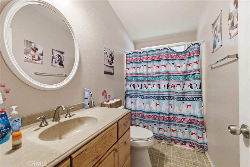 21552 Sprague Road West Groveland, CA 95321 - Photo 13 of 36 a bathroom with a sink a mirror and a toilet