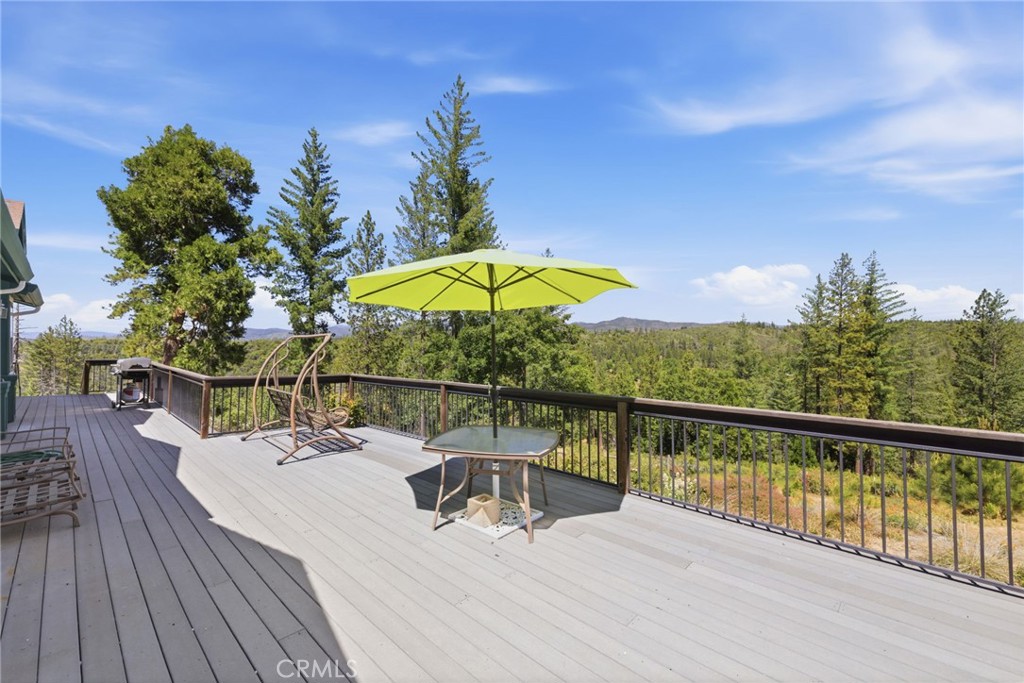 21552 Sprague Road West Groveland, CA 95321 - Photo 17 of 36 a view of a balcony with wooden floor and outdoor seating