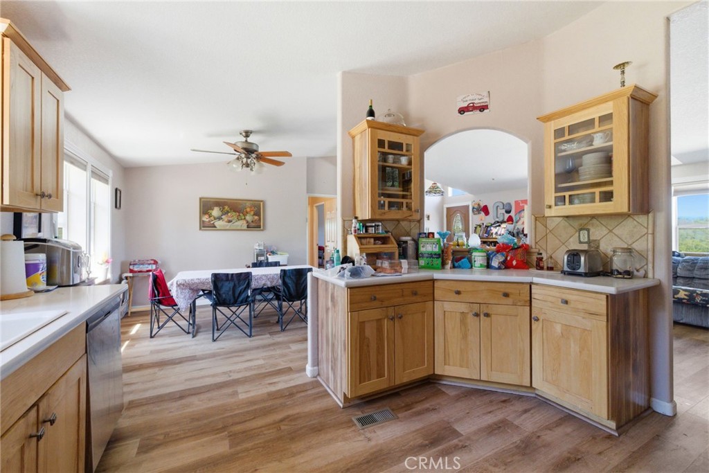 21552 Sprague Road West Groveland, CA 95321 - Photo 9 of 36 a kitchen with a sink dining table and chairs