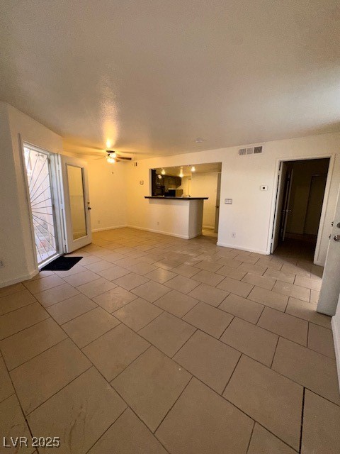 1830 North Pecos Road, Unit 155 Las Vegas, NV 89115 - Photo 8 of 23 Unfurnished living room with light tile patterned