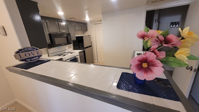 1830 North Pecos Road, Unit 155 Las Vegas, NV 89115 - Photo 10 of 23 Kitchen featuring black microwave, white gas range
