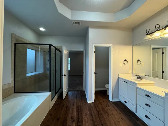 a spacious bathroom with a double vanity sink and a mirror
