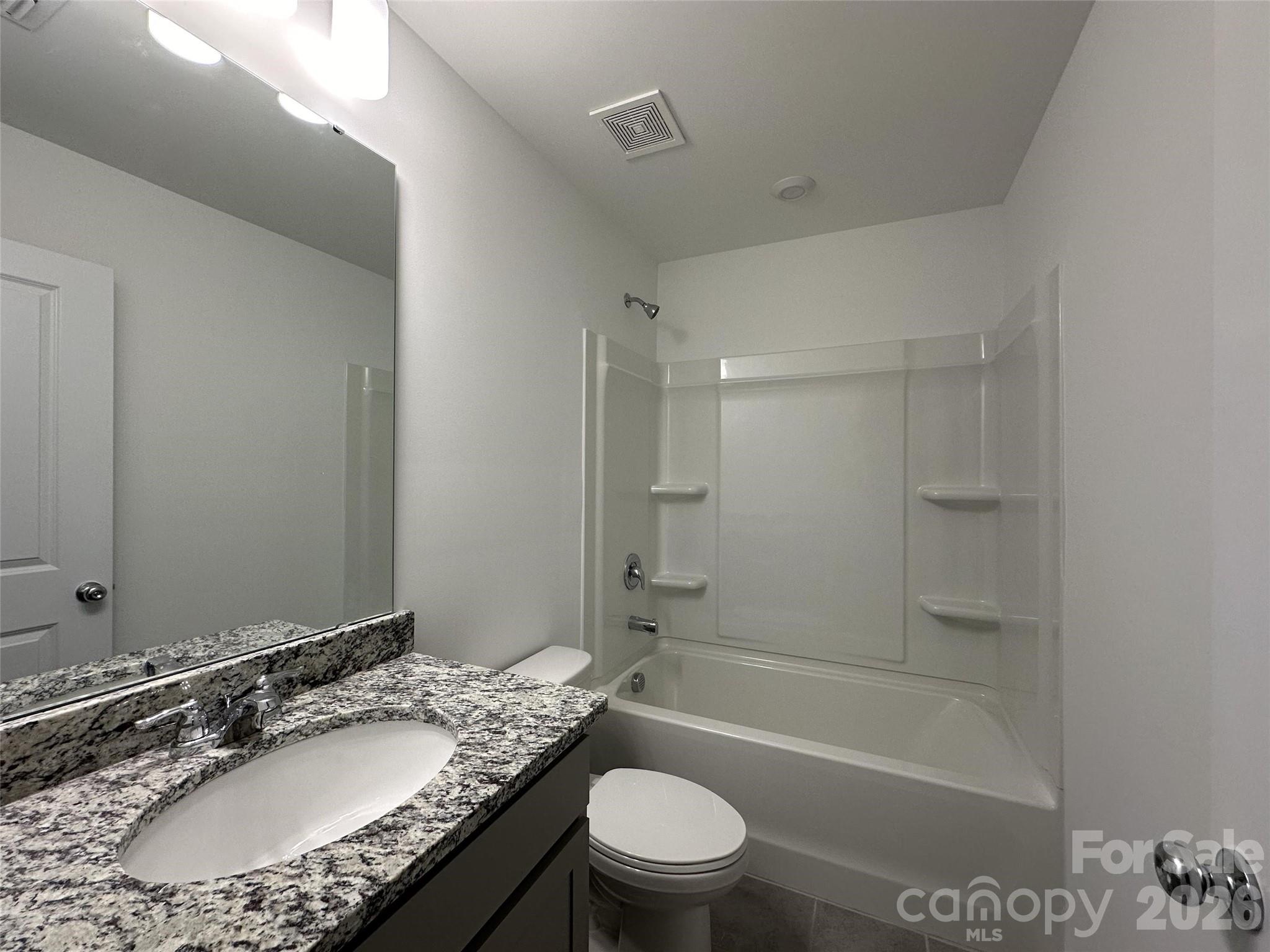 1872 Teachers House Road Northwest Concord, NC 28027 - Photo 13 of 14 a bathroom with a granite countertop sink toilet and shower