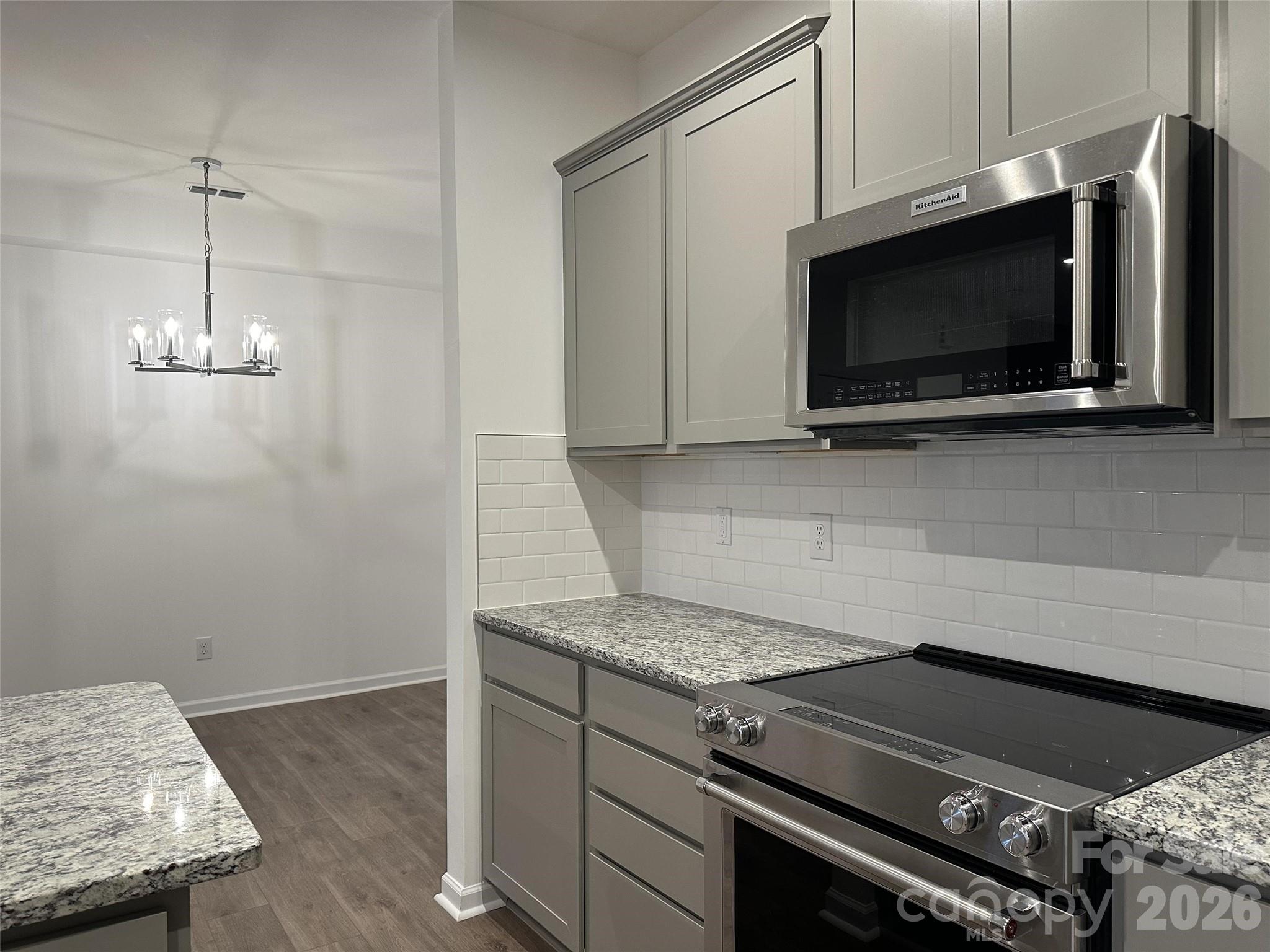 1872 Teachers House Road Northwest Concord, NC 28027 - Photo 6 of 14 a kitchen with granite countertop a stove and a microwave