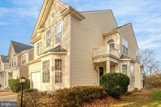 a front view of a residential apartment building with a yard