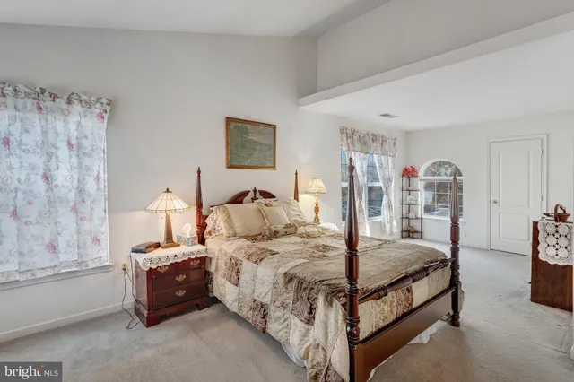 a bedroom with bed and a window