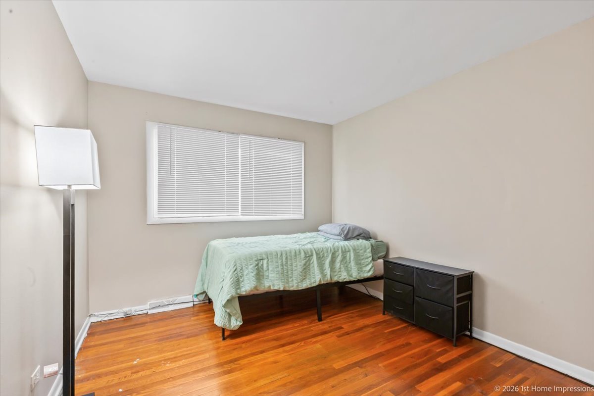 18847 May Avenue Homewood, IL 60430 - Photo 14 of 26 a bedroom with a bed and a window