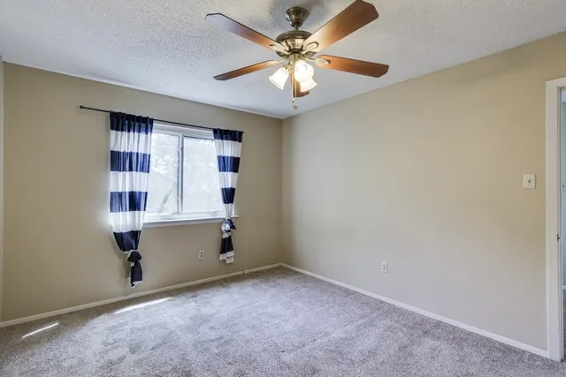 a room with window and ceiling fan