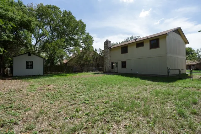 a view of a park with large trees