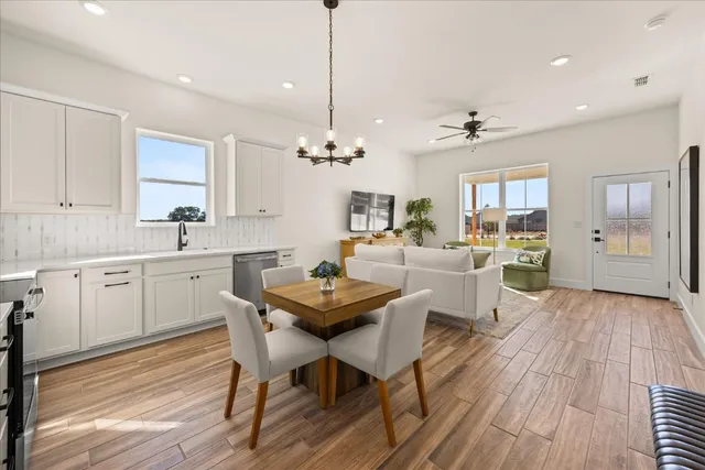 a view of a dining room with furniture and wooden floor