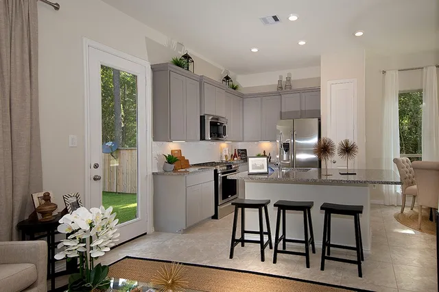 a kitchen with sink table and chairs