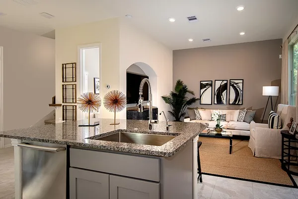 a kitchen with sink refrigerator and stove