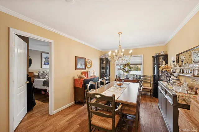a kitchen with sink refrigerator dining table and chairs