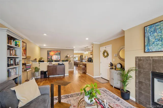 a living room with furniture kitchen view and a large window