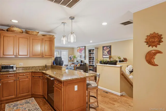 a kitchen with stainless steel appliances granite countertop a refrigerator a stove a sink and a microwave