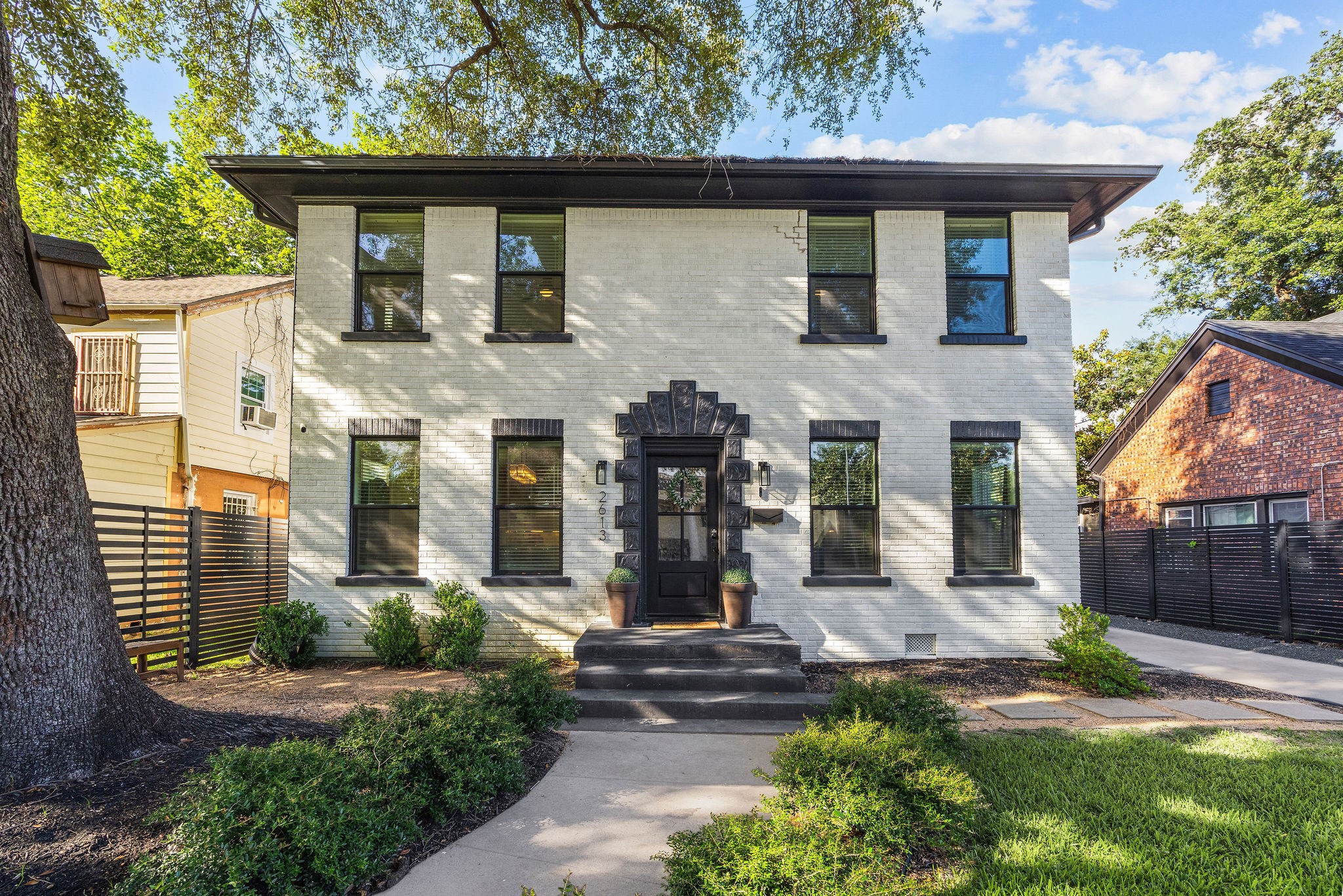 2613 Wichita Street Houston, TX 77004 - Photo 1 of 25 Beautifully updated exterior blending historic character with modern updates, highlighted by original architectural details and mature landscaping.