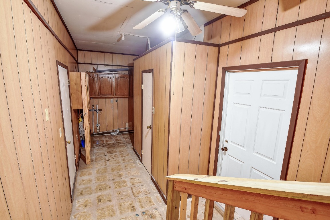 17398 Benton City Road Von Ormy, TX 78073 - Photo 18 of 25 a view of hallway with wooden walls and stairs